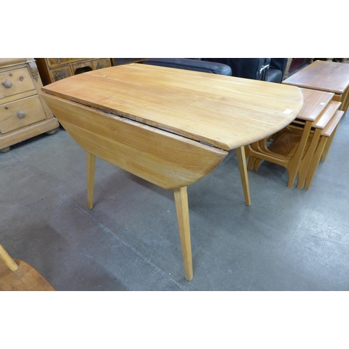 73 - An Ercol Blonde elm and beech drop leaf table