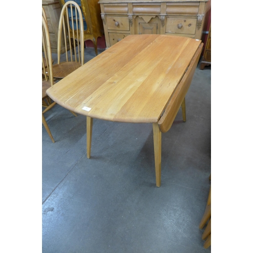 73 - An Ercol Blonde elm and beech drop leaf table