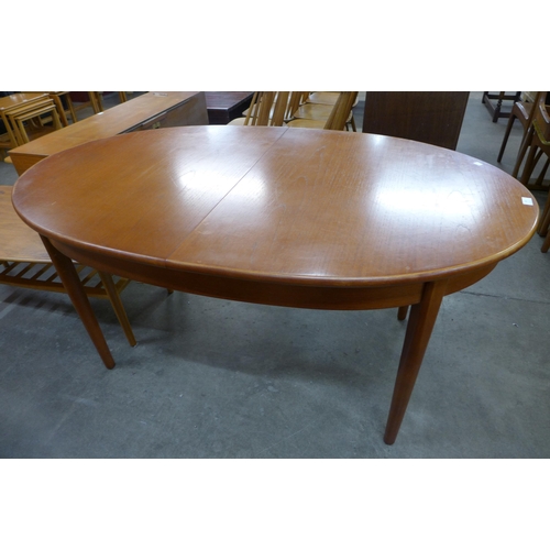 83 - A Jentique teak extending dining table