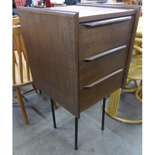 85 - A teak three drawer chest on steel stand