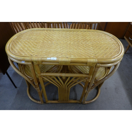 88 - A bamboo and rattan table and two chairs