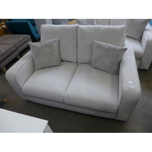 1328 - A frost white with grey piping corduroy upholstered two seater sofa