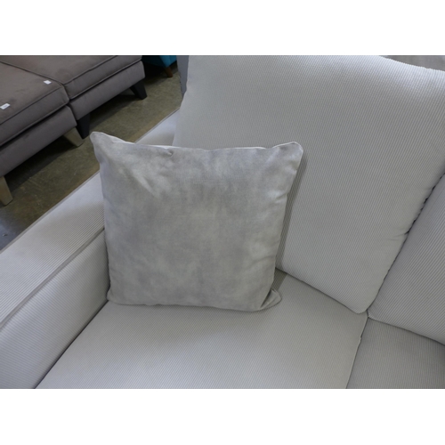 1329 - A frost white with grey piping corduroy upholstered two seater sofa