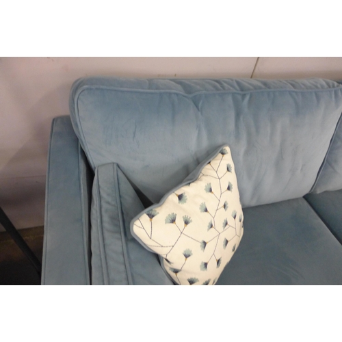 1344 - A diamond blue velvet three seater sofa with floral scatter cushions