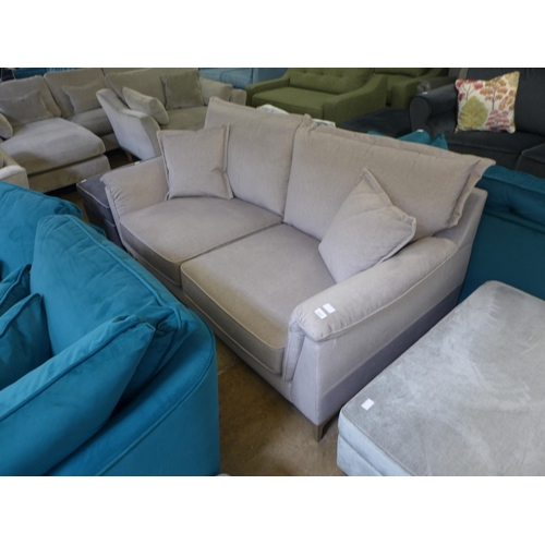 1317 - A concrete grey upholstered three seater sofa