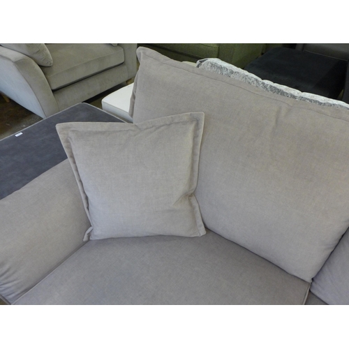 1317 - A concrete grey upholstered three seater sofa