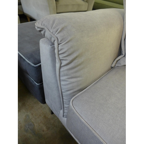 1317 - A concrete grey upholstered three seater sofa