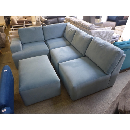 1382 - A sky blue velvet sectional corner sofa and footstool