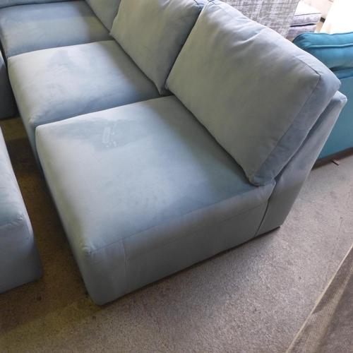 1382 - A sky blue velvet sectional corner sofa and footstool