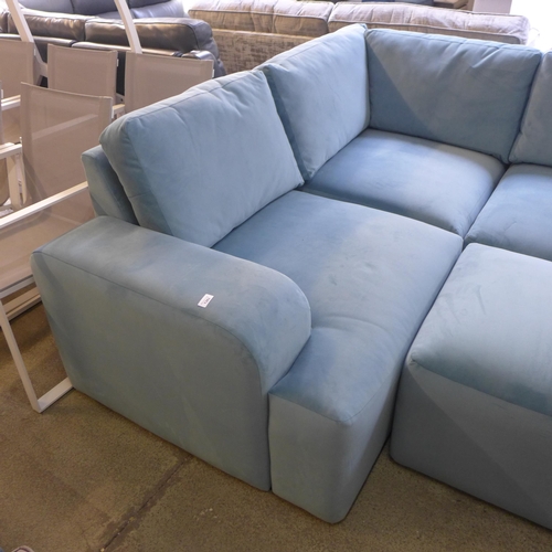 1382 - A sky blue velvet sectional corner sofa and footstool