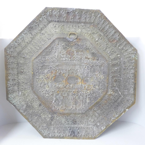 612 - An Indian embossed octagonal brass plaque, 59cm