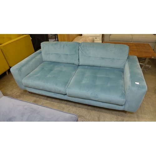 1330 - An aquamarine pinch back velvet three seater sofa