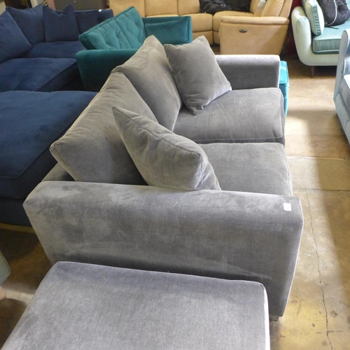 1344 - A fossil grey velvet three seater sofa and ottoman footstool