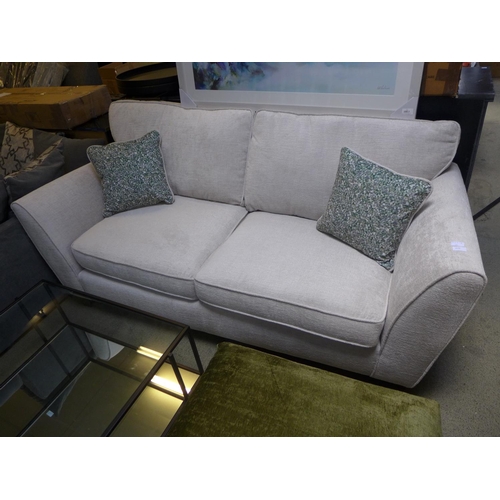 1410 - A Bone upholstered three seater sofa with green patterned scatter cushions