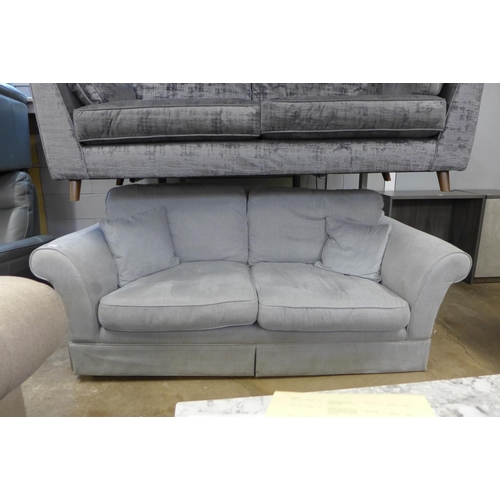 1426 - A fossil grey upholstered three seater sofa