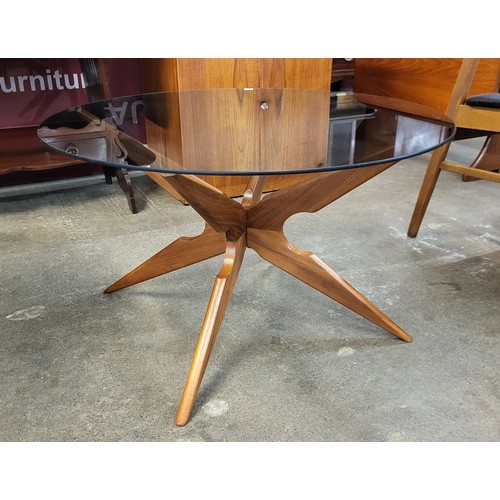 25 - A Danish Sika Mobler teak and glass topped circular spider leg coffee table, designed by Vladimir Ka... 
