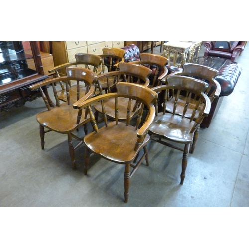 125 - A set of eight early 20th Century elm and beech smokers bow chairs