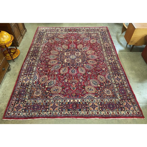 135 - A large Persian red ground rug