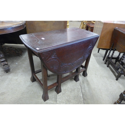 157 - An early 20th Century carved oak gateleg table