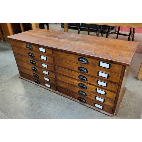 124 - A Victorian style stained pine counter top bank of drawers