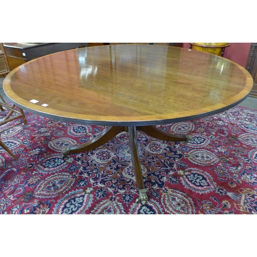 115 - A Regency style inlaid mahogany circular dining table