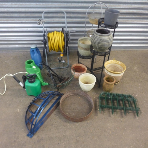 2238 - Job lot of gardening equipment; hose pipe, watering cans, plant pots, etc.