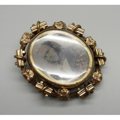 1032 - A large Victorian gold plated photograph pendant/brooch with double sided swivel section