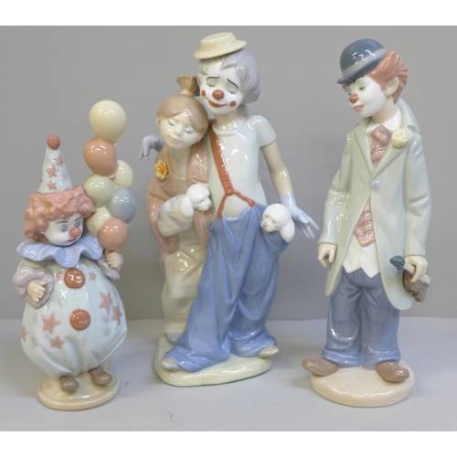 606 - Three Lladro figures of clowns, one a/f (fingers)