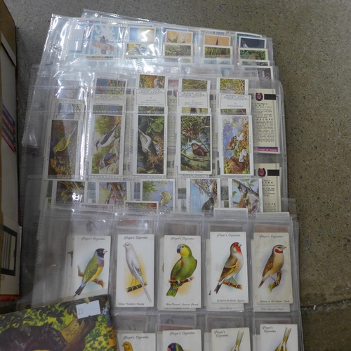 696 - Cigarette cards; a box of cigarette and trade cards in albums and sleeves