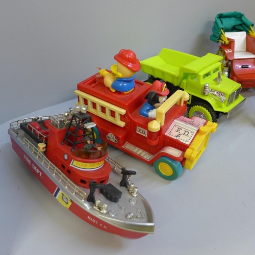 697 - Toys including Marx Hill climbing dump truck, Disney fire engine, Fire Department boat, a boxed bull... 