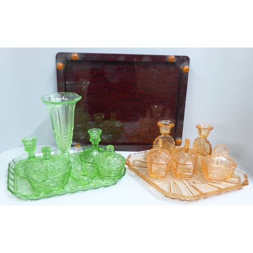 776 - Two glass dressing table sets and a Bakelite tray