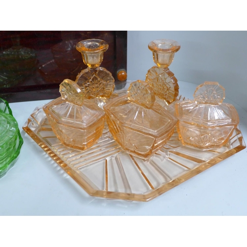 776 - Two glass dressing table sets and a Bakelite tray