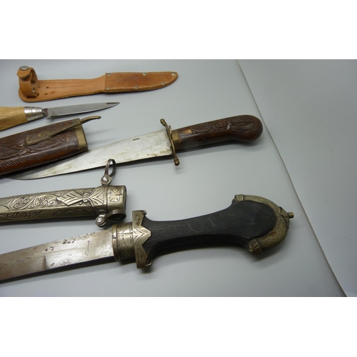 790 - An Eastern dagger with scabbard, one with hoof handle and scabbard and one other dagger