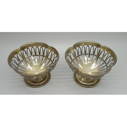 824 - A pair of pierced silver Walker & Hall sweetmeat dishes, Sheffield 1910, 76.6g