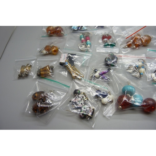 853 - Twenty pairs of earrings with silver hooks