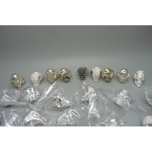 856 - Thirty-nine silver plated brass skull rings