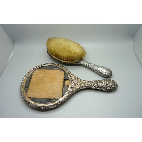 858 - A silver hand mirror back and brush, a/f