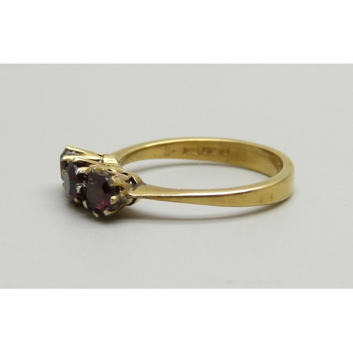 895 - A silver gilt and garnet three stone ring, M