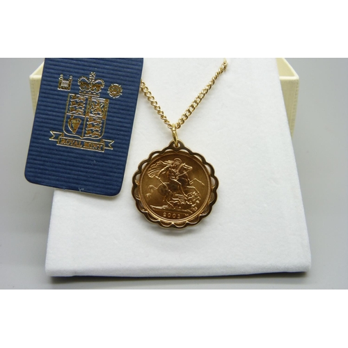 923 - A 2001 gold proof sovereign mounted in 9ct gold pendant mount on a 9ct gold chain, total weight 16.1... 