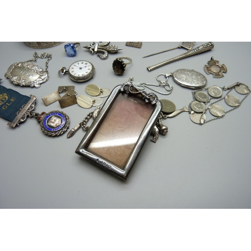 956 - A Victorian silver photograph frame, a silver fob watch, a silver whisky label, a hallmarked silver ... 