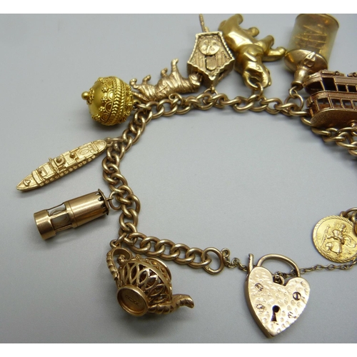 964 - A 9ct gold charm bracelet, with twelve hallmarked 9ct gold charms and a yellow metal charm, 73.3g