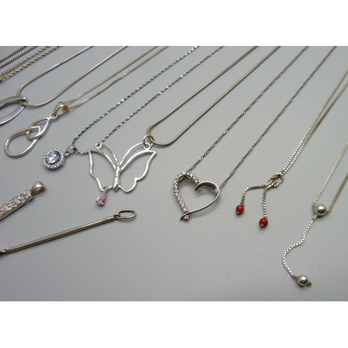 965 - A collection of silver pendants and chains