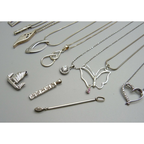 965 - A collection of silver pendants and chains