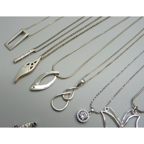 965 - A collection of silver pendants and chains