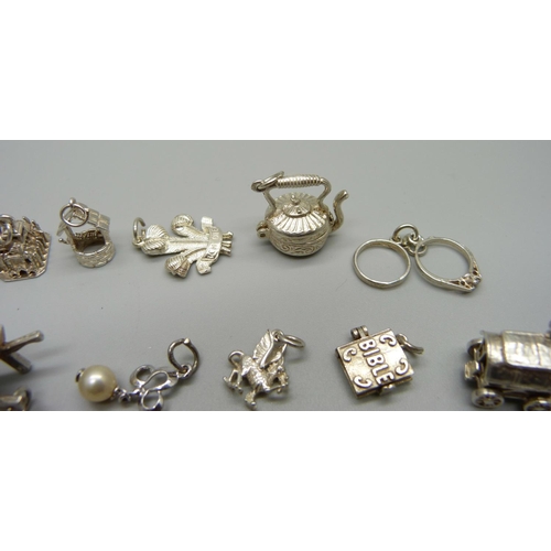 969 - Twenty-five silver and white metal charms, all stamped or test as silver, 68g