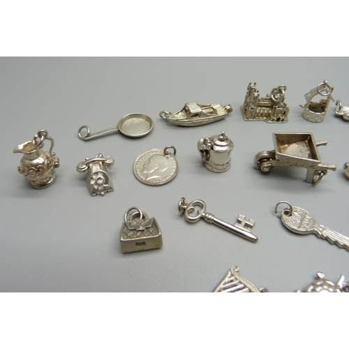 969 - Twenty-five silver and white metal charms, all stamped or test as silver, 68g