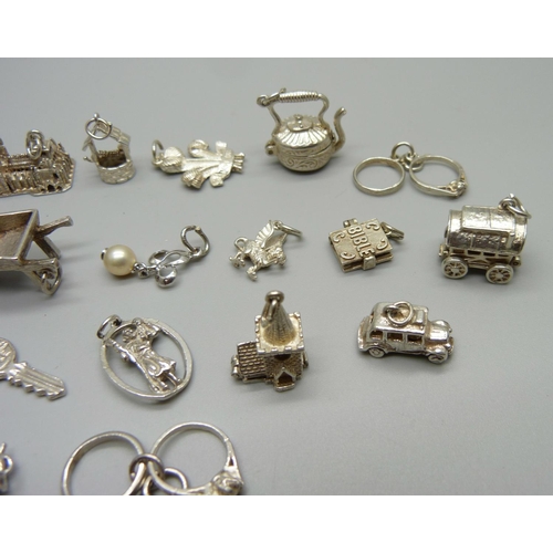 969 - Twenty-five silver and white metal charms, all stamped or test as silver, 68g