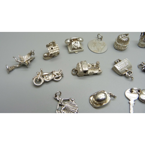 979 - Twenty-five silver and white metal charms, all stamped or test as silver, 72g