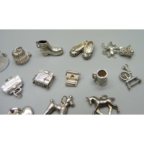 979 - Twenty-five silver and white metal charms, all stamped or test as silver, 72g