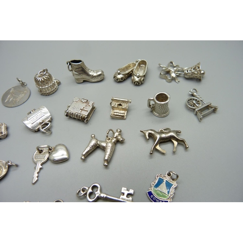 979 - Twenty-five silver and white metal charms, all stamped or test as silver, 72g